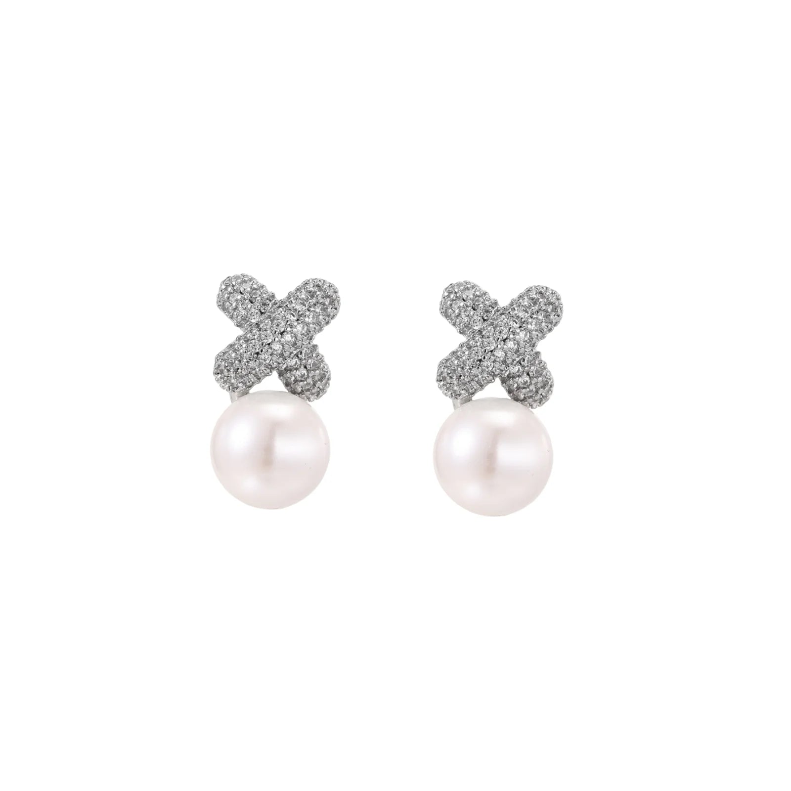 White gold plated studs featuring pavé X-shaped tops with freshwater pearl drops on cream background.
